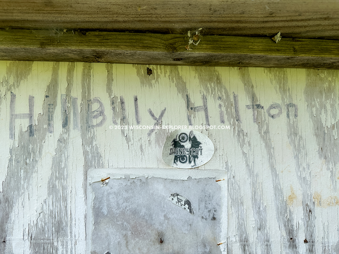 poorly painted wood door with marker writing