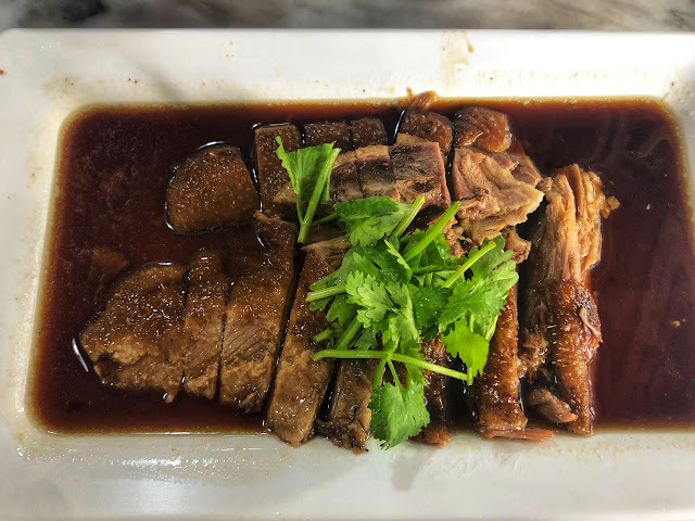 a platter of Thai-Chinese braised goose served with cilantro