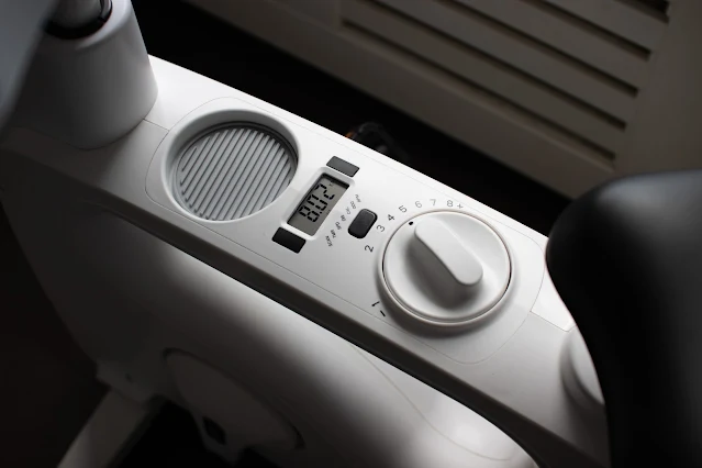 Close up of the body part of the V9 Pro cycle desk showing cup holder, display screen and resistance dial