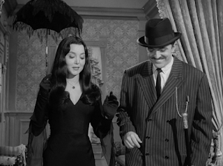 Morticia with parasol and Gomez for a night on the town