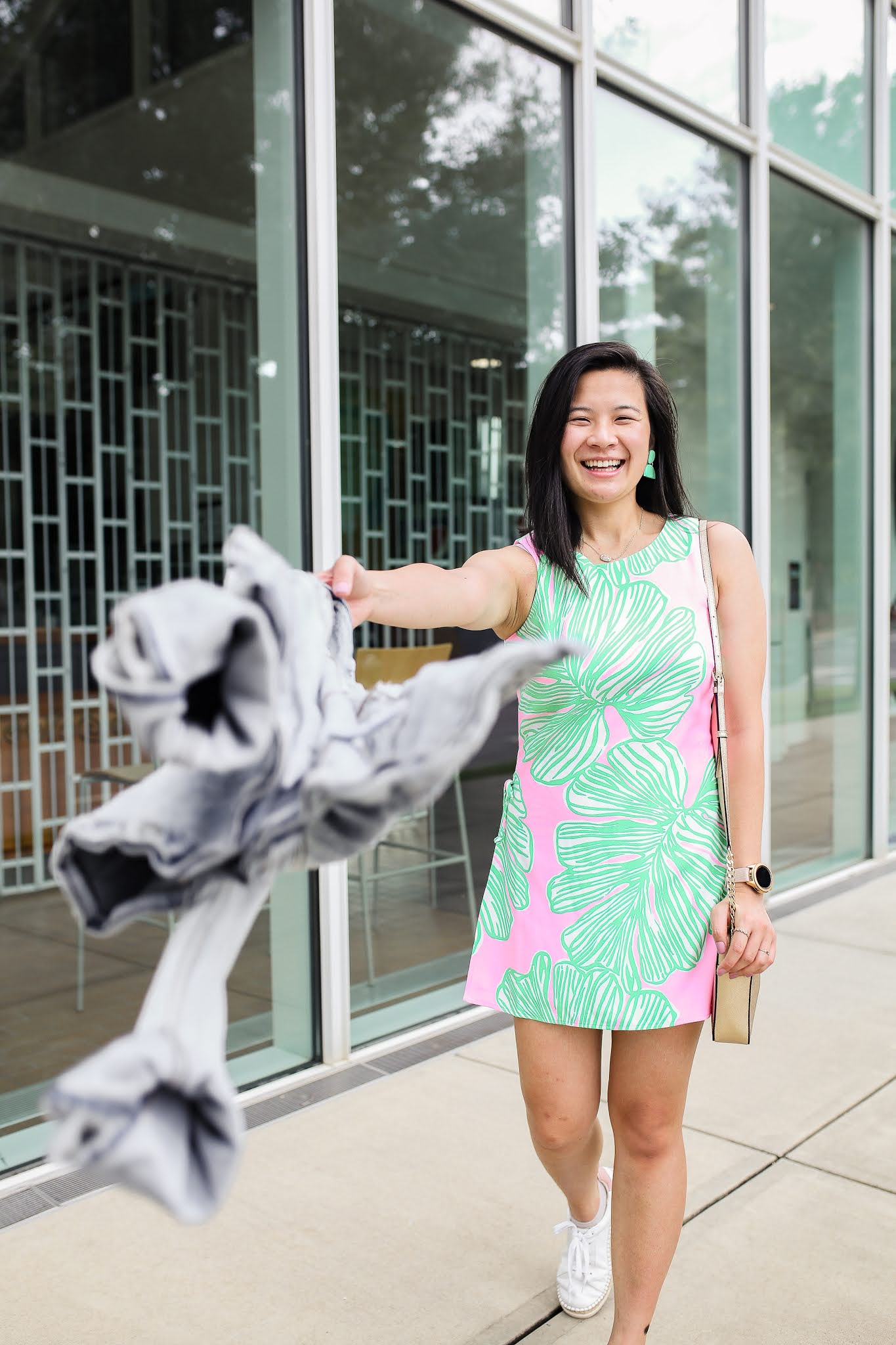 how to pose for your next photoshoot: swinging your handbag in front of the camear