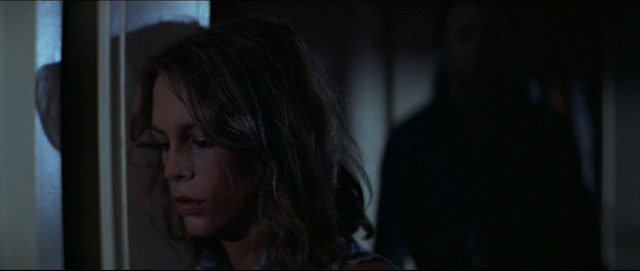 Laurie Strode (Jamie Lee Curtis) does not realize Michael Myers has risen behind her in HALLOWEEN (1978).