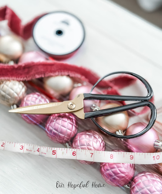 quilted pink and gold Christmas ornaments with scissors and frayed velvet ribbon and scissors