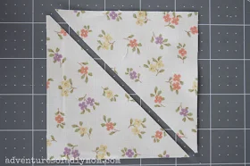 square of fabric cut into two triangles