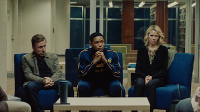 Luce 2019 movie still where Tim Roth, Kelvin Harrison Jr., and Naomi Watts sit together during a meeting with Kelvin's teacher and principal at school