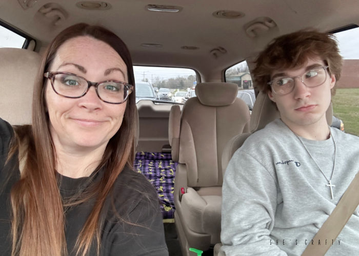 Teen boy and mom in car with glasses.