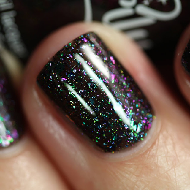 black nail polish with multichrome flakes and holo
