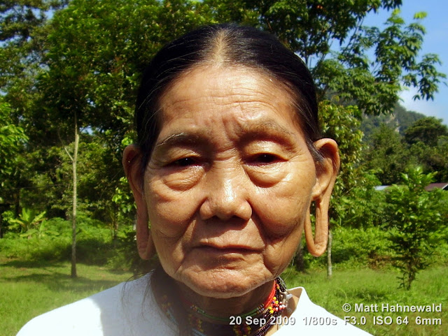 Penan woman, street portrait, headshot, elongated earlobes, stretched earlobes, holes in earlobes, Borneo, Sarawak, Gunung Mulu National Park, Batu Bungan