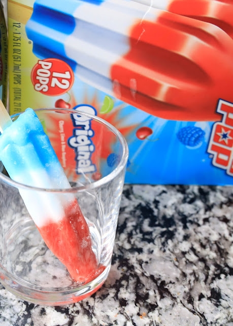 popsicle in a glass with popsicle box in the background.