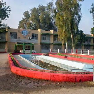 A photo of the Sukkur board of education building, a white and blue structure with a sign that says “Board of Intermediate and Secondary Education Sukkur