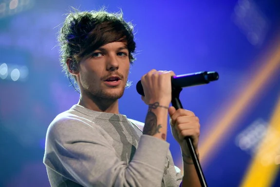 One Direction singer Louis Tomlinson will trade in his microphone for football boots next month