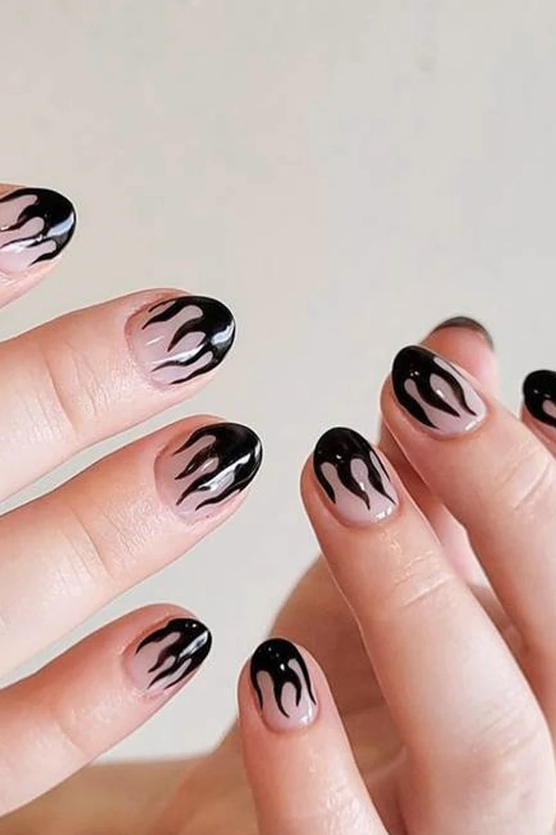 close-up of woman hand with a very cute and minimal halloween nail design