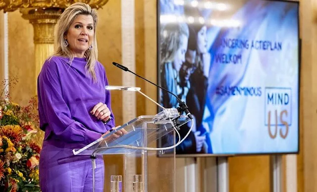 Purple silk blouse and purple trousers. JAR Paris amethyst and diamond earrings. Natan coat. Christian Louboutin purple pumps