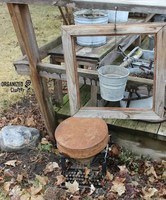 Photo of a junky garden planter vignette.