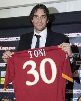 AS Roma new striker Luca Toni poses with his jersey during a news conference