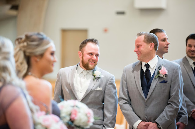 groom crying as bride walks down the isle at St. Paul's Catholic Church in Clinton Township