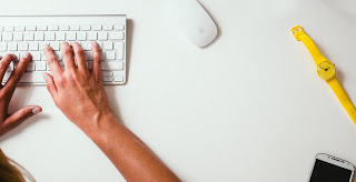 person typing on a wireless keyboard