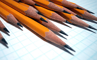 yellow sharpened pencils for editing stacked together neatly