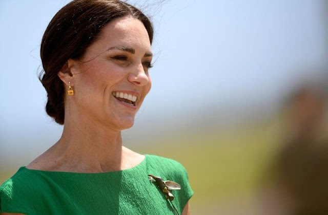 Kate Middleton wore a green Denver midi dress by Emilia Wickstead. Queen's Hummingbird Brooch. Kiki McDonough citrine earrings
