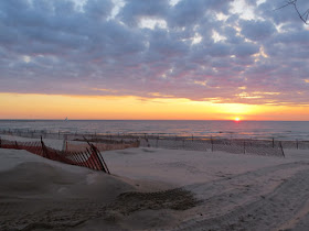 sunset over Lake Michigan with sand fencing