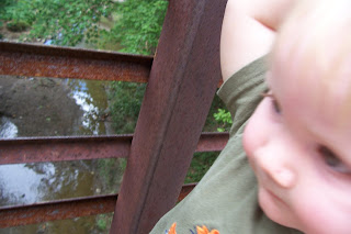 toddler on bridge over creek