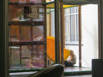 child reading in indoor playground