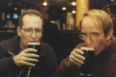 Cormac and Dan drinking pints in a pub.