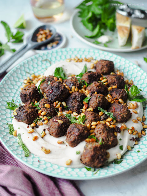Spicy herb meatballs on a cool bean puree. An oriental-inspired favorite meal for the summer.
