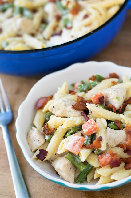 The finished one pot creamy chicken and vegetable pasta in a bowl on the counter. 