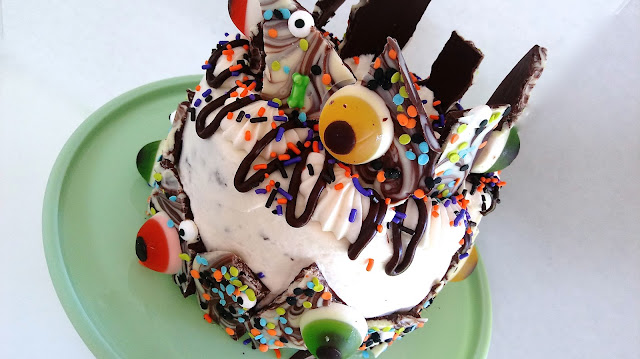 a layer cake decorated with spooky eyeball Halloween chocolate bark