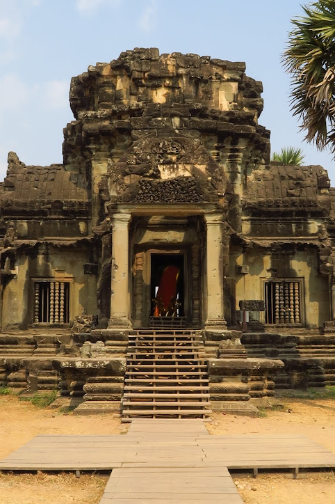 One of the entrances on the West Wall. Vishnu could be seen inside the entrance, beneath the partially collapsed tower. Angkor Wat
