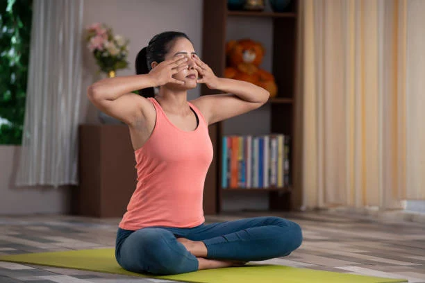 Young woman practicing yoga breathing exercise at home
