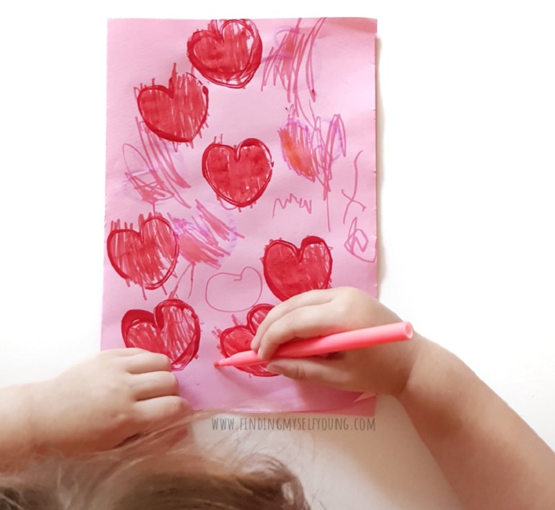 toddler colouring in heart prints