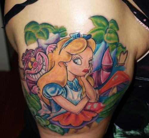 Alice with Cheshire Cat tattoo on right shoulder
