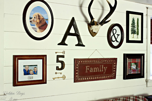 gallery wall on planked wall in family room-www.goldenboysandme.com