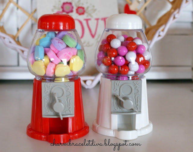 Mini gumball machines filled with conversation hearts and candy coated chocolate