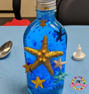 Ocean in a Bottle: This is an image of a bottle filled with blue water and ocean-themed objects like shells and starfish. Kids can make their own ocean in a bottle using simple materials like water, oil, and food coloring.