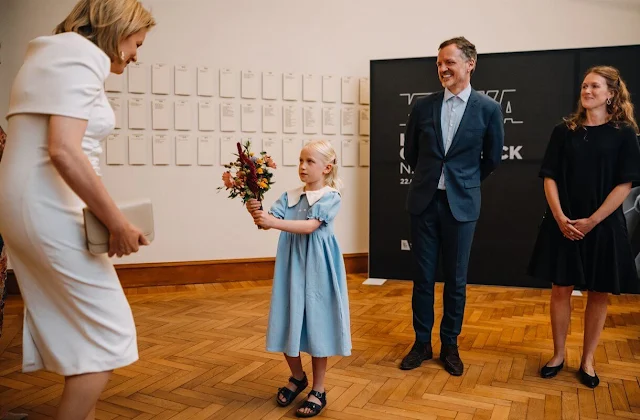 Queen Mathilde wore a white cape style dress by Natan. Nocturnal Journey exhibition at KMSKA