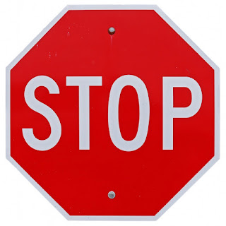 a bright red, octagonal stop sign with large white letters