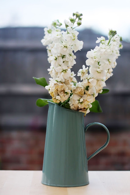 A photo of a jug holding flowers