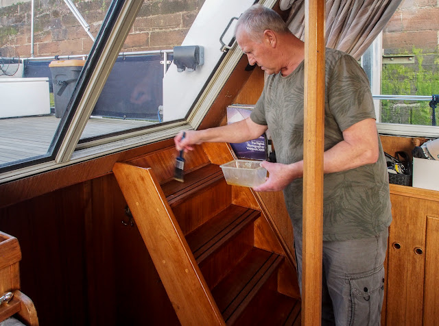 Photo of Phil applying the first coat of varnish