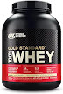 A container of vanilla-flavored whey protein powder from Optimum Nutrition, with white background, black lid, and a label in the front with the brand name, product name, and nutritional facts information.