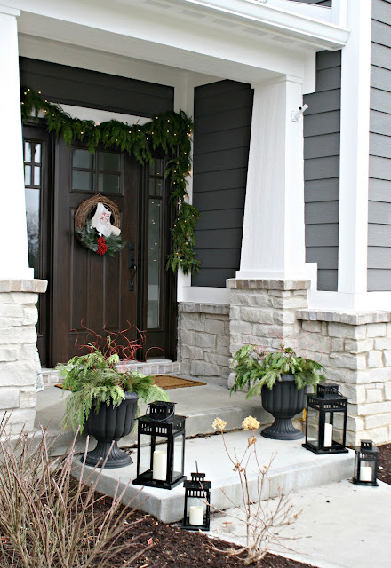 Christmas porch with greenery and lanterns