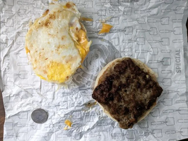 Wendy's Sausage, Egg & Cheese English Muffin split apart top-down view.