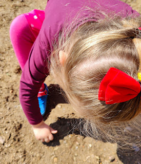 Rosie planting sunflower seeds