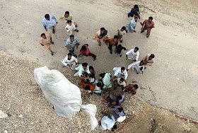Bags with supplies are dropped from a Pakistani Army