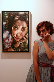 02-Helena-next-to-her-portrait-Nikos-Gyftakis-Swirls-of-Colors-and-Shapes-used-in-Portrait-Paintings-www-designstack-co