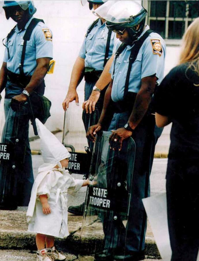 35 moments of violence that brought out incredible human compassion - child touches his reflection during a kkk demostration