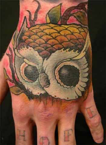 side of hand tattoos. Owl hand design photo.