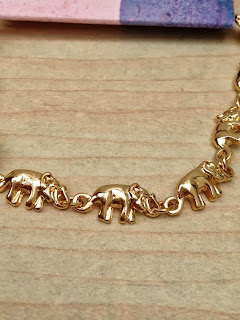 Close up detail of the individual elephants on the bracelet 